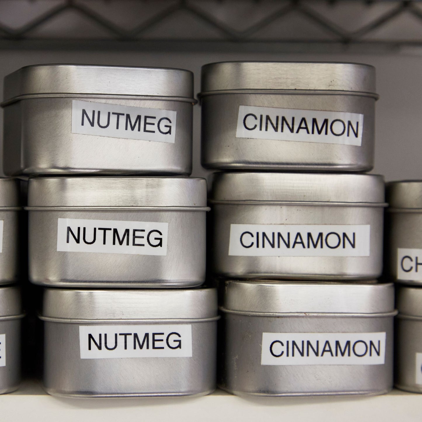 Tins of Indian spices - nutmeg, cinnamon, coriander