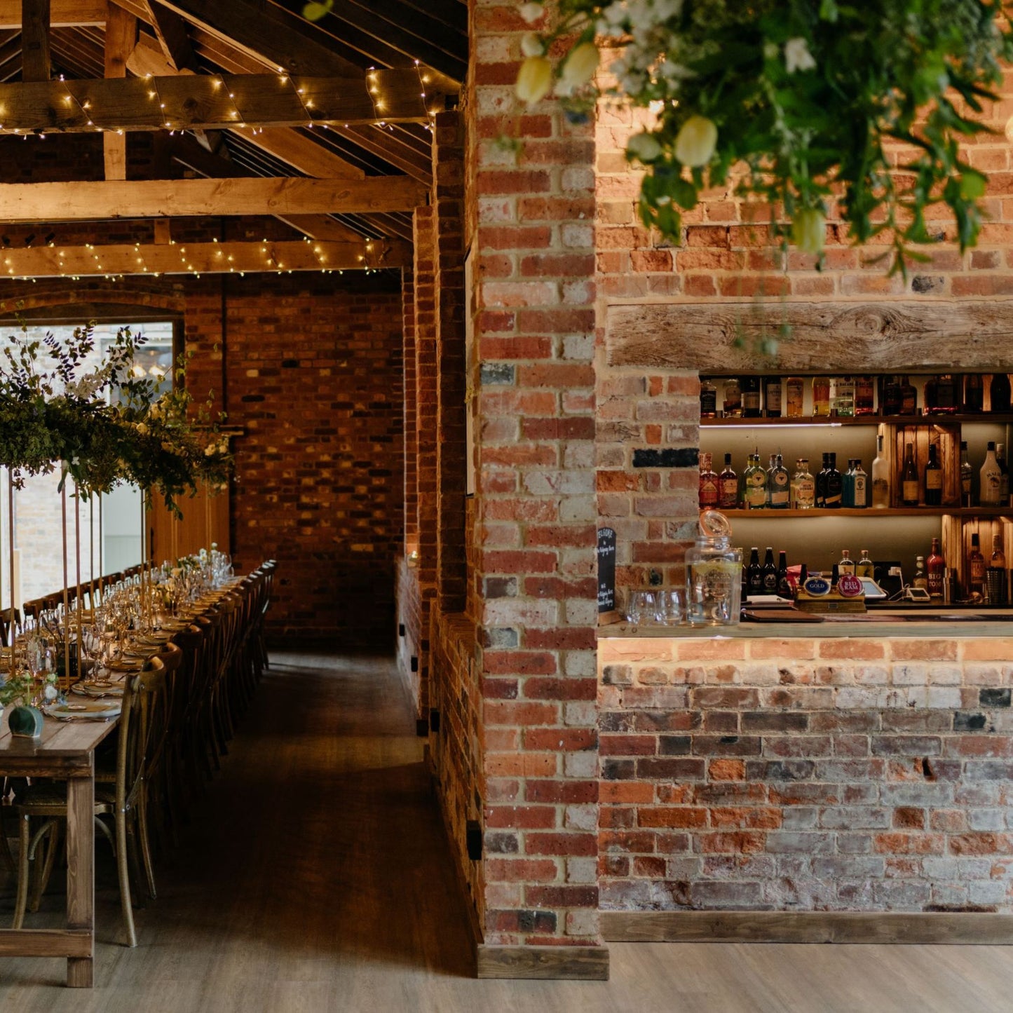 Long tables set for a meal, fully stocked bar