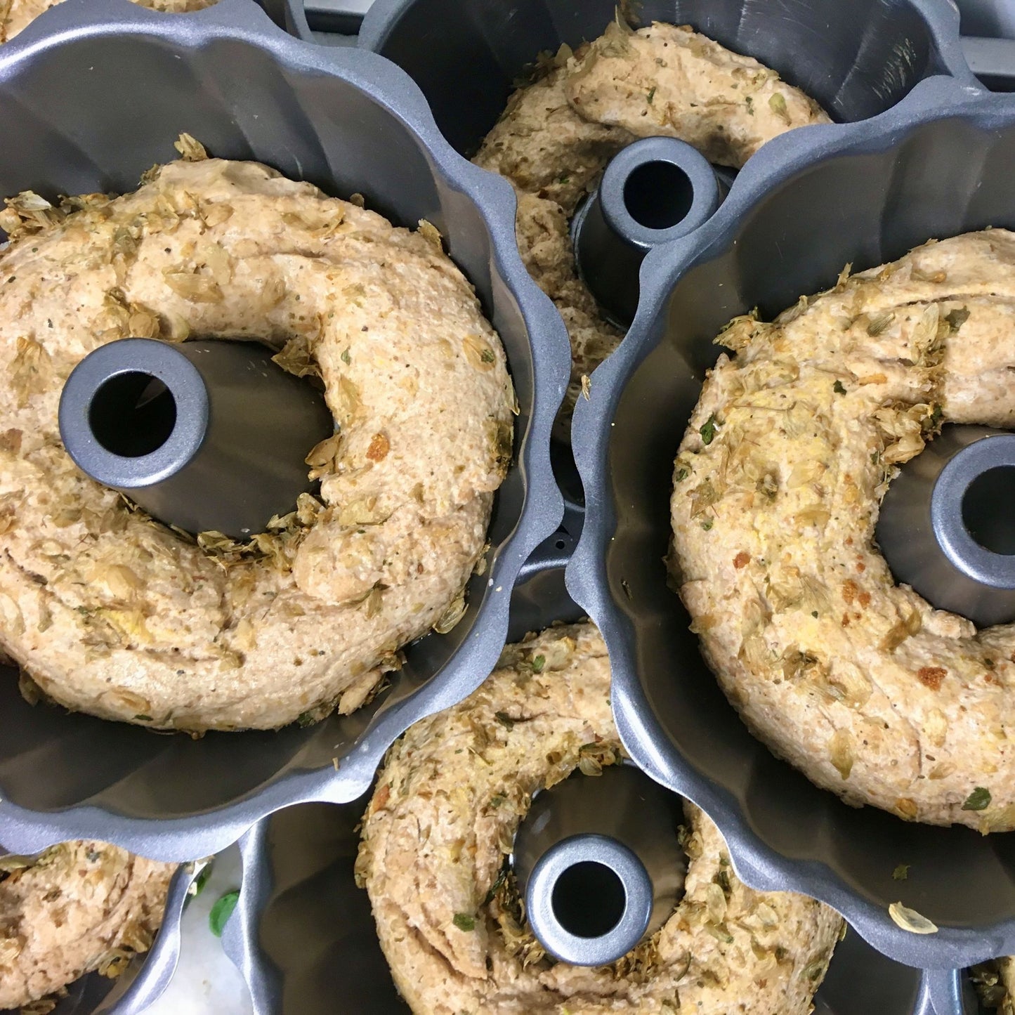 Bread dough ready for baking in round tins stacked on top of each other
