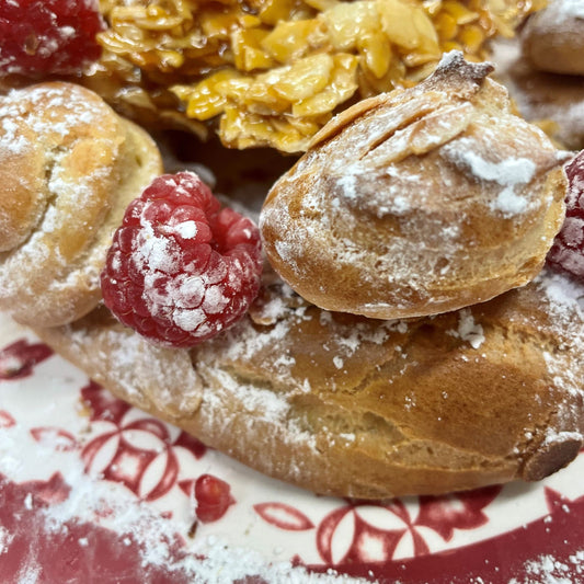 Vegan choux pastry with raspberry and icing sugar