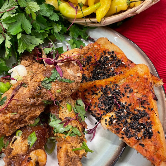 Thai prawn toast on a plate and Thai ingredients in the background