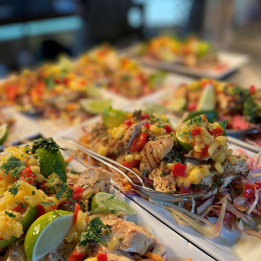 White platters loaded with Barbados slaw, mango & chilli, lime wedges