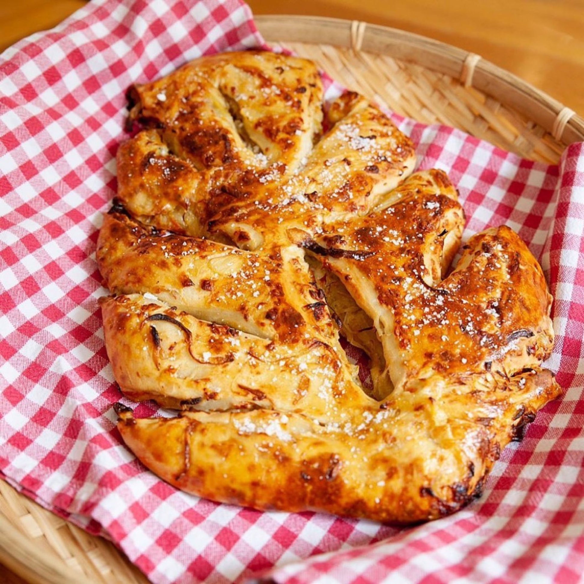 Fougasse bread on a gingham cloth in a basket