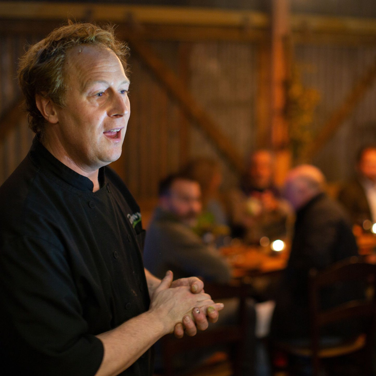 Chef Peter Vaughan telling about the food with guests watching