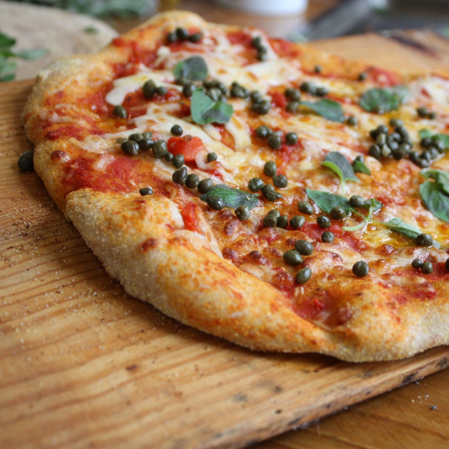 Pizza with capers, cheese and sage, homemade pizza dough, fresh pizza