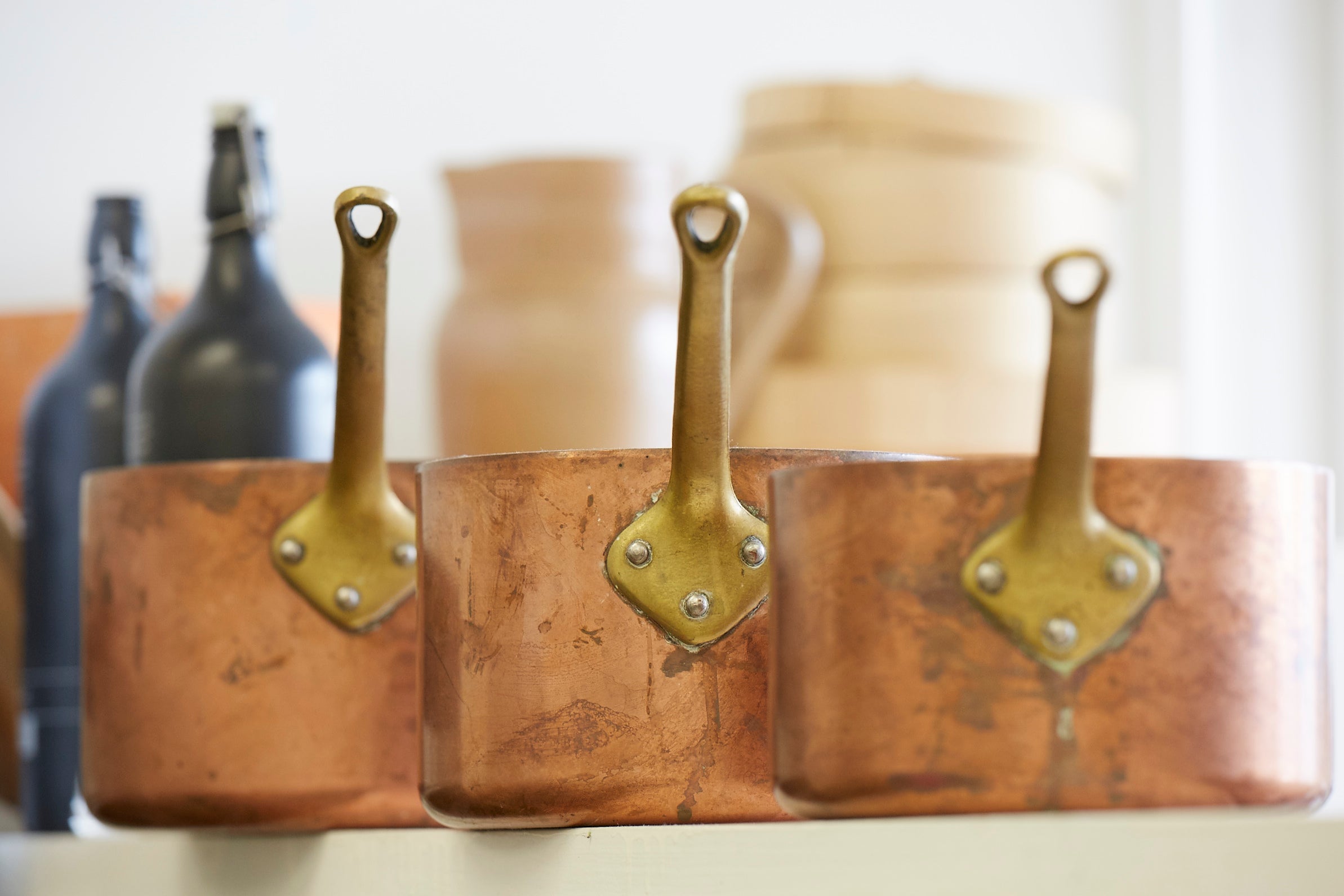 A row of copper pans